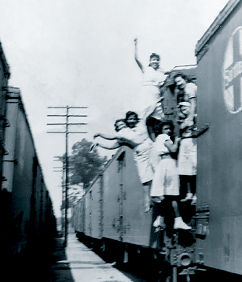 Angie Lopez & Friends Hanging on Side of Train.